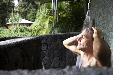 Man bathing in outdoor shower