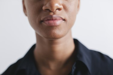 Woman's mouth and nose in front of white background