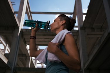 Girl drinking water after exercising