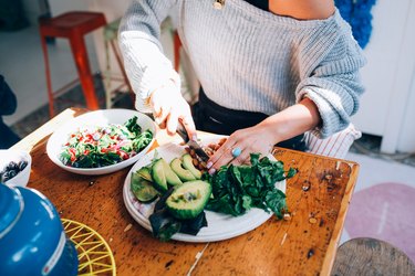Hands of woman preparing salad