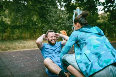 Female Fitness Instructor Working Out With Client