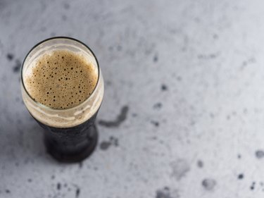 A glass of strong dark beer of the porter view from above copyspace
