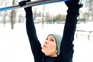 Female athlete exercising in park in winter