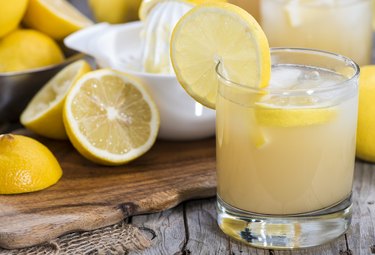 Arrangement of glass with fresh lemonade with ingredients
