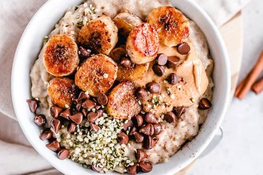 Cinnamon oatmeal with fried banana, nut butter, chocolate chip and hemp seeds