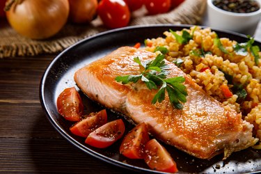 Healthy fat-rich salmon dinner with groats and vegetables