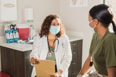 ob-gyn doctor talking to a patient during her annual exam