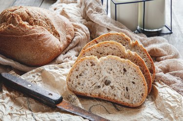 homemade sourdough rye frozen bread on a plate and milk