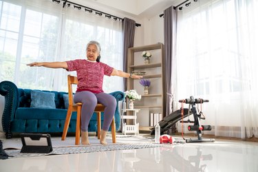Senior woman doing workout with spread both arms and jog