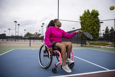 young person in wheelchair learning how to play pickleball