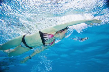 Underwater shot of Asian woman swimming